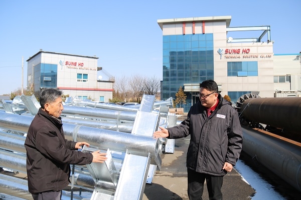 김윤식 대표와 조동환 공장장이 용융아연도금 처리 된 태양광 구조물을 두고 이야기를 나누고 있다. [사진=Industry News]