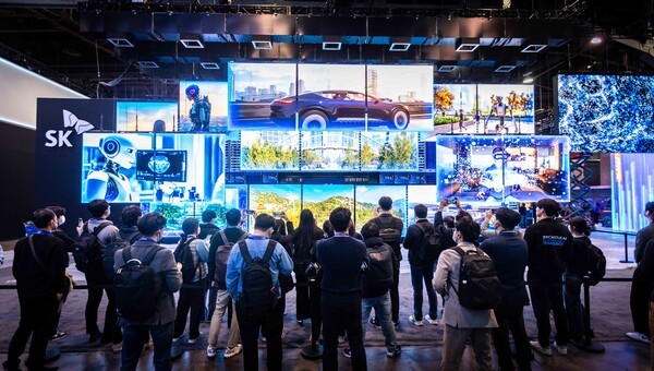 CES 2025 SK그룹 전시관 입구 정면에 설치된 '혁신의 문' 앞에 관람객들이 모여 있다./사진=SK